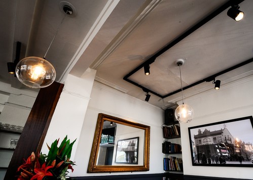 Track lights and glass globe pendants over bar