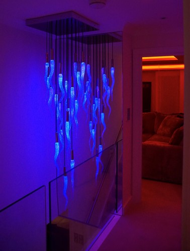 Pendant above staircase with RGBW downlights