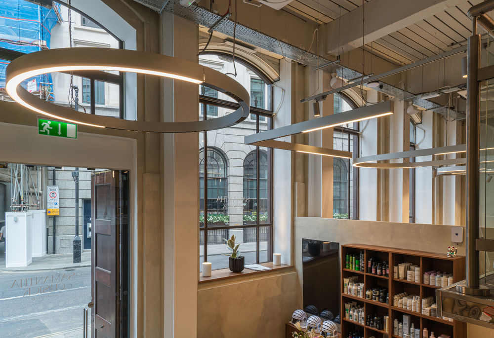 A Serpent ring and racetracks suspended over the entrance and retail display of the salon
