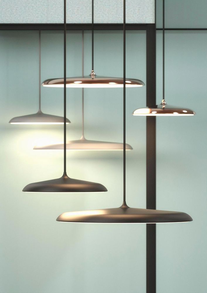 Nordlux Artist pendant lights over a dining area