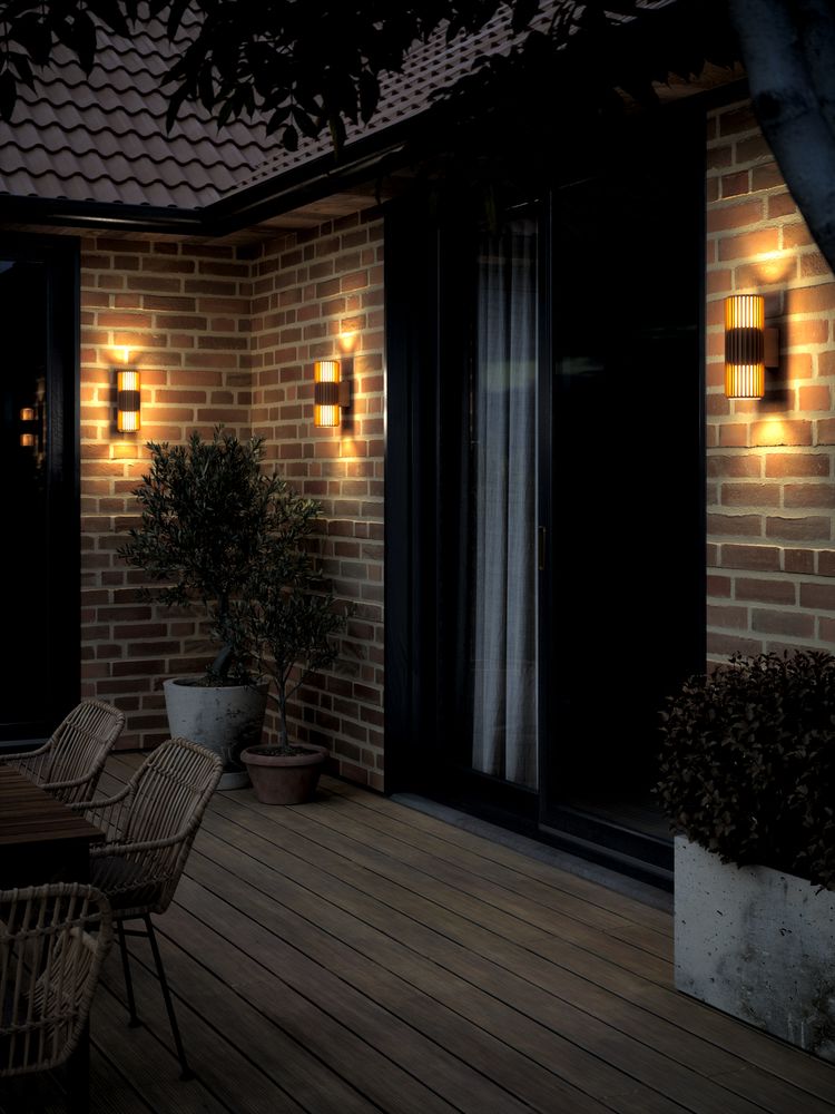 Nordlux Aludra outdoor wall lights on a brick terrace at dusk